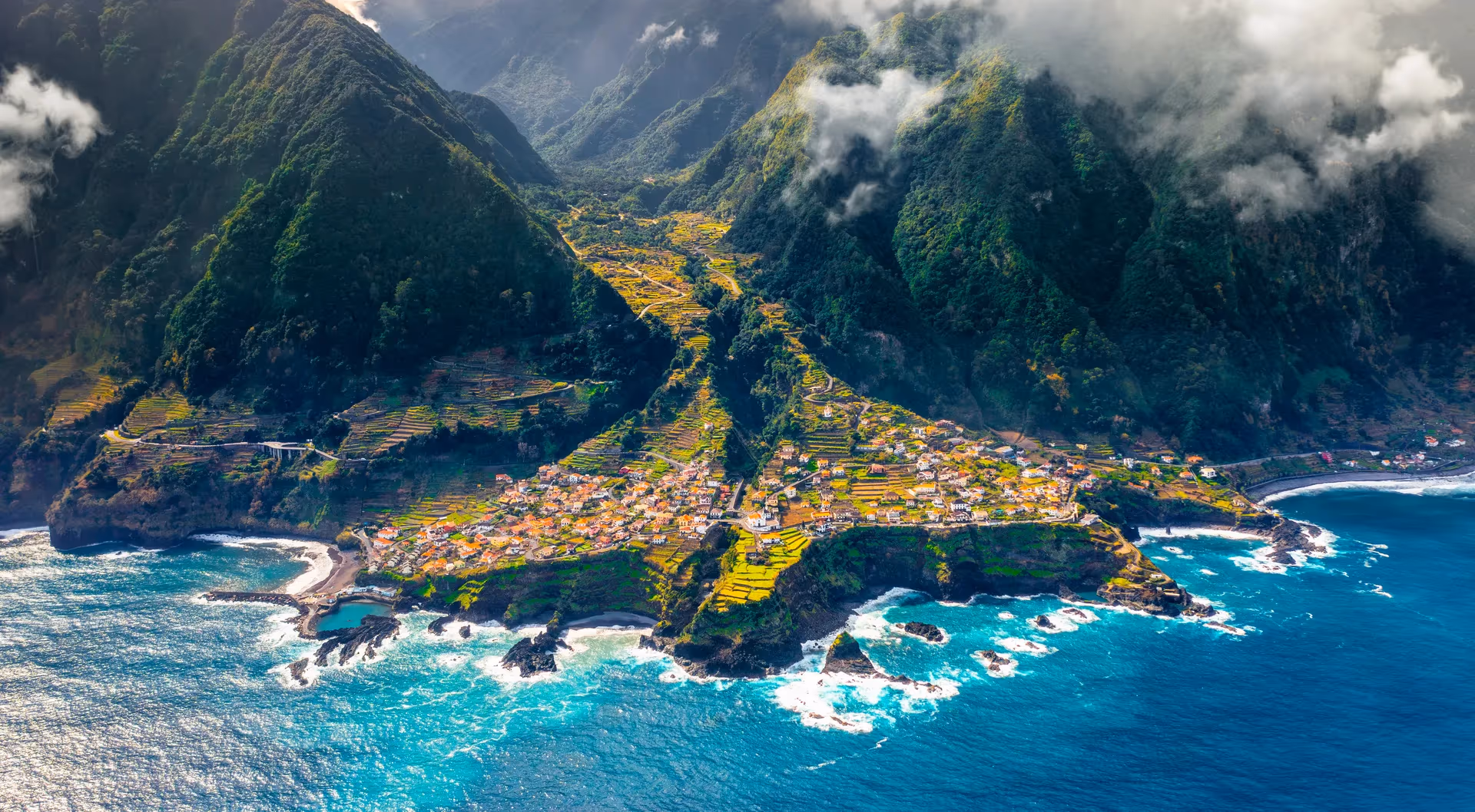 Cliffs of Madeira's south coast above the Atlantic in warm evening light