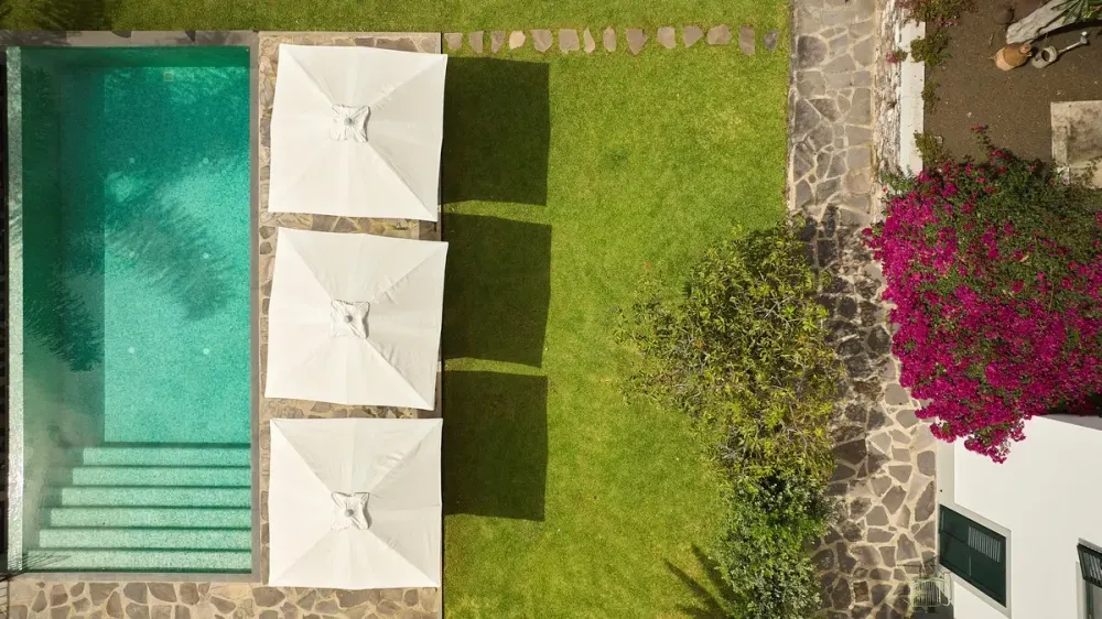 Traditional Madeiran townhouse bedroom with embroidered linens at Bordal Houses, Funchal
