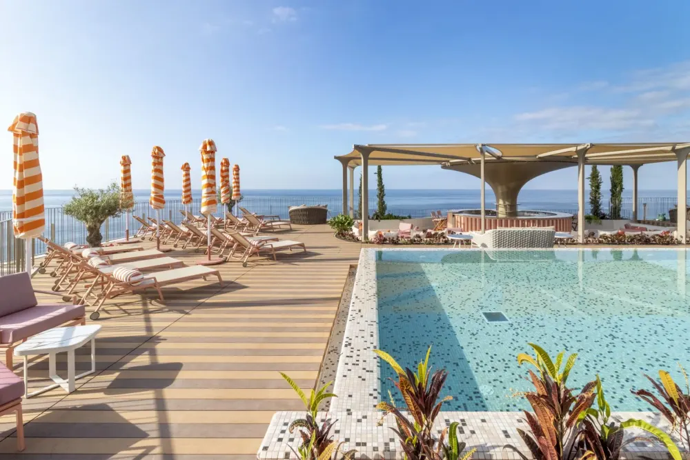 Bright contemporary room at NEXT by Savoy Signature with the Funchal bay beyond, Madeira