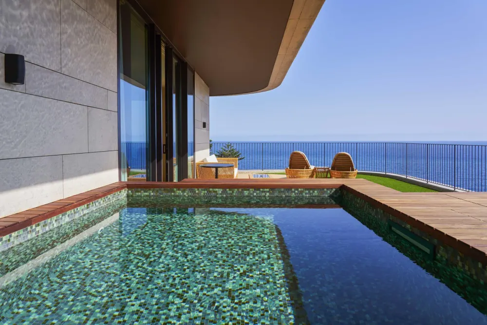 Muted, dark-toned suite interior at The Reserve, the adults-only top floors of the Savoy Palace, Funchal